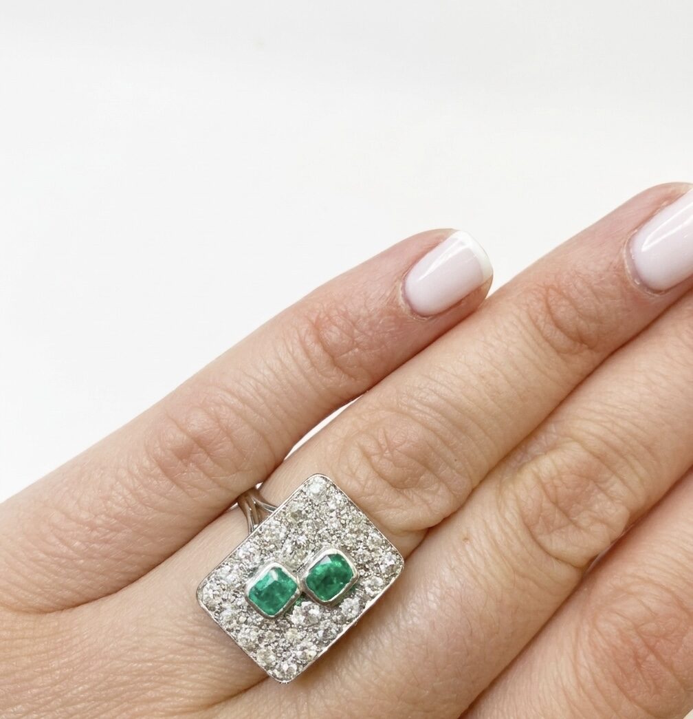 White gold ring with emeralds and diamonds