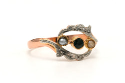 Yellow gold ring with an emerald, pearls, and diamonds