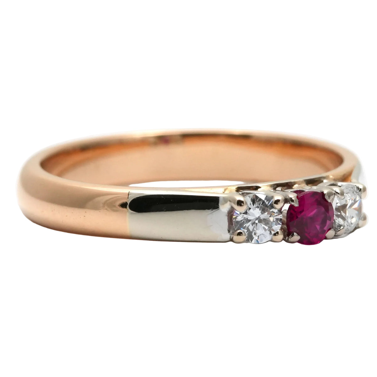Trilogy Ring in white gold, yellow gold, rubies, and diamonds