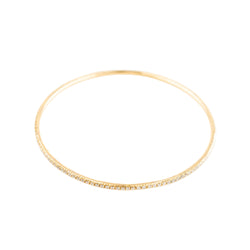 Three bangle bracelets in white gold, yellow gold, rose gold, and diamonds
