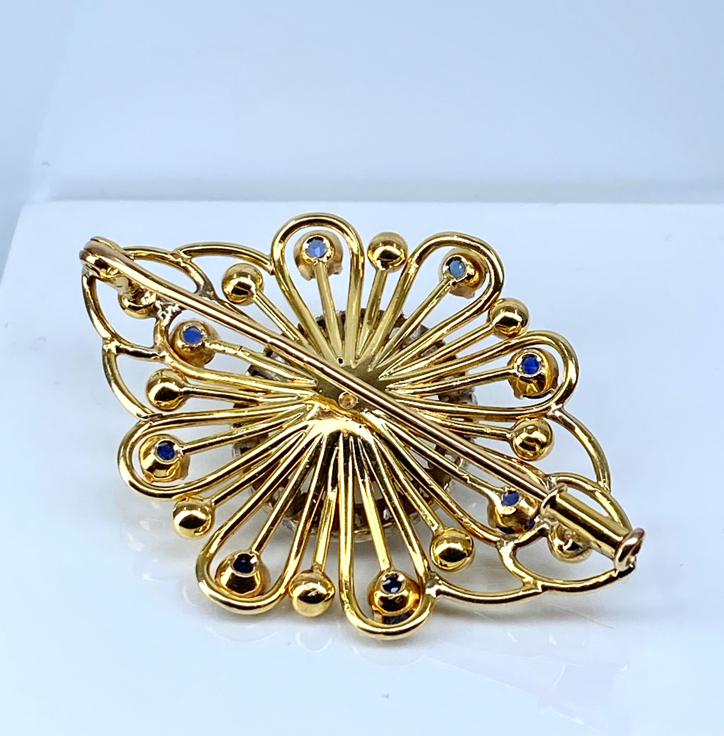 Gold brooch with sapphires, a pearl, and diamonds
