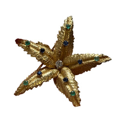 BOUCHERON brooch in yellow gold, emeralds, sapphires, and diamonds