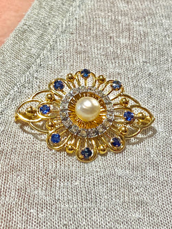 Gold brooch with sapphires, a pearl, and diamonds