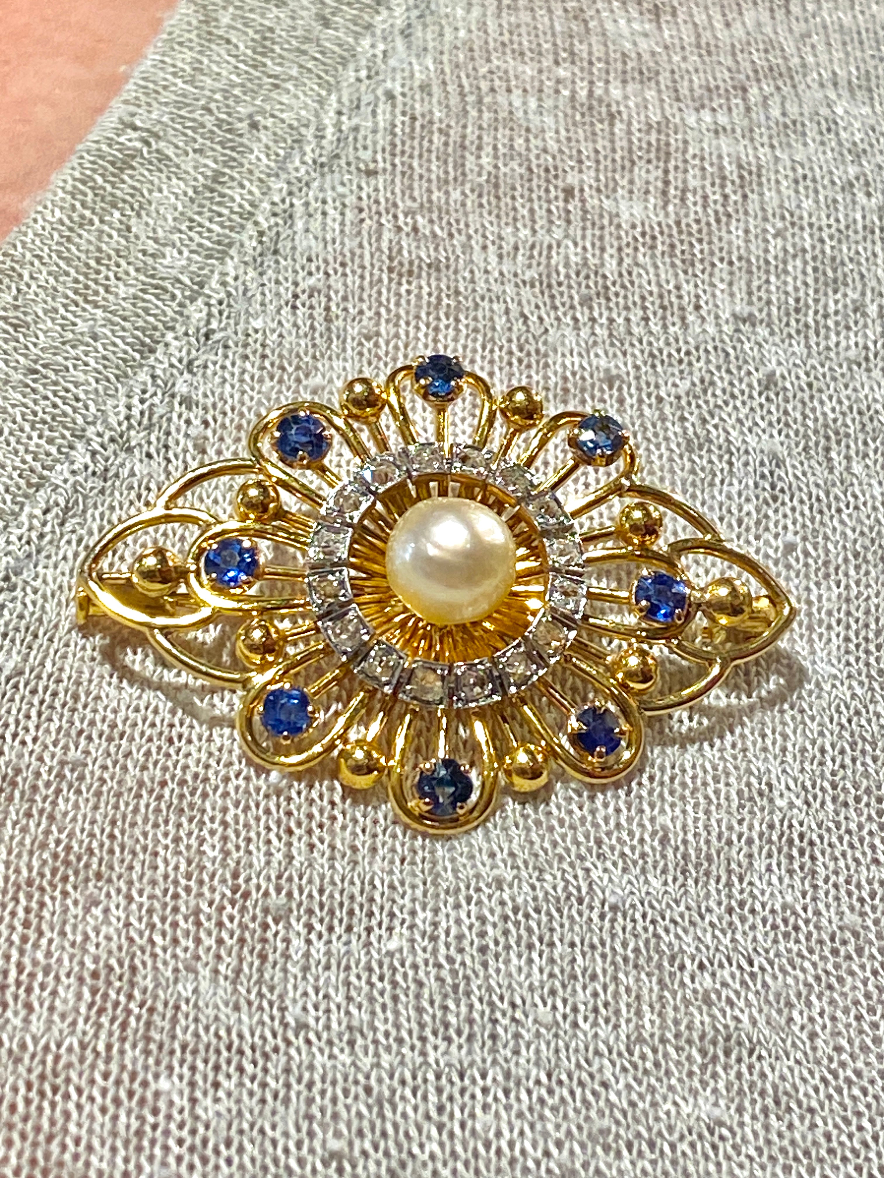 Gold brooch with sapphires, a pearl, and diamonds