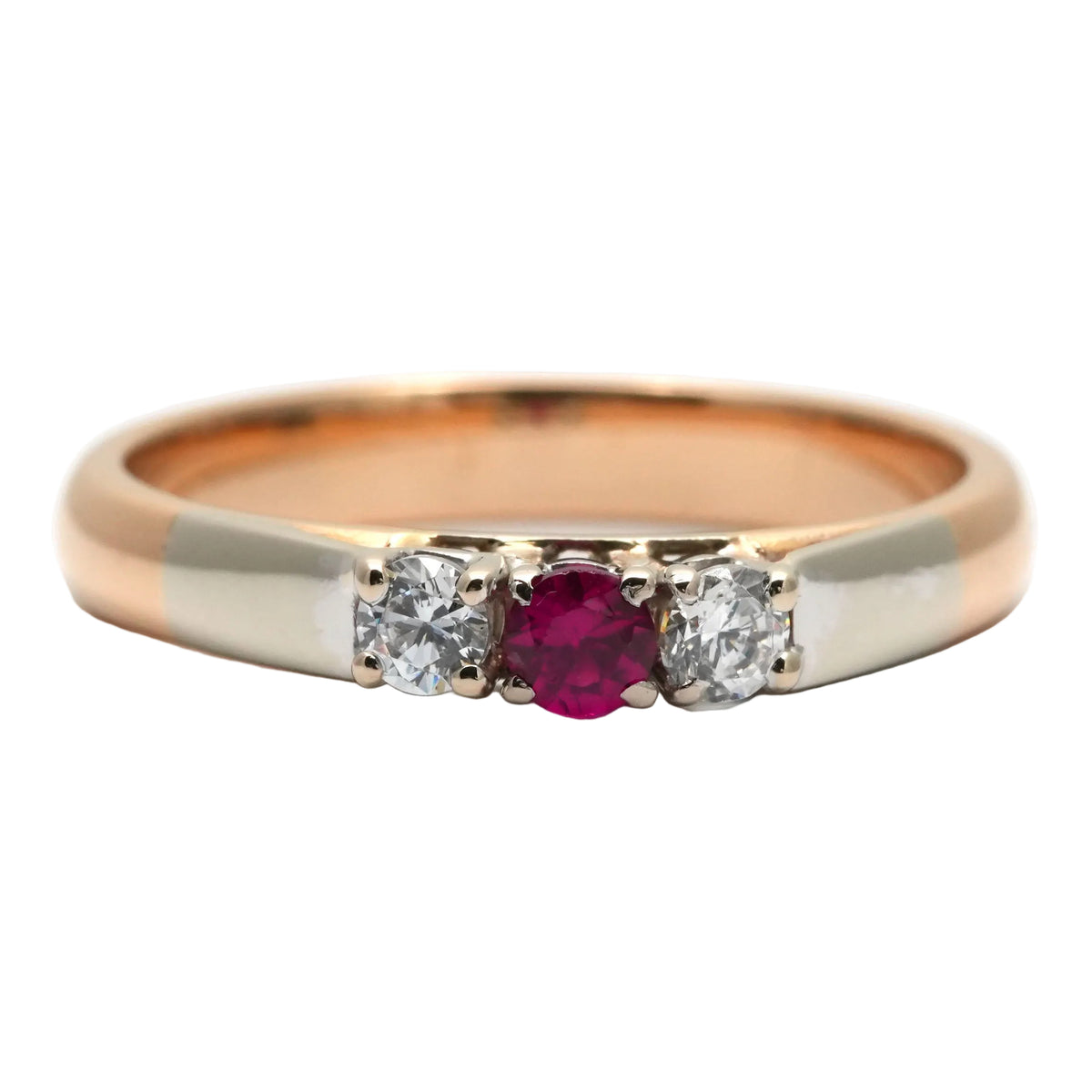 Trilogy Ring in white gold, yellow gold, rubies, and diamonds