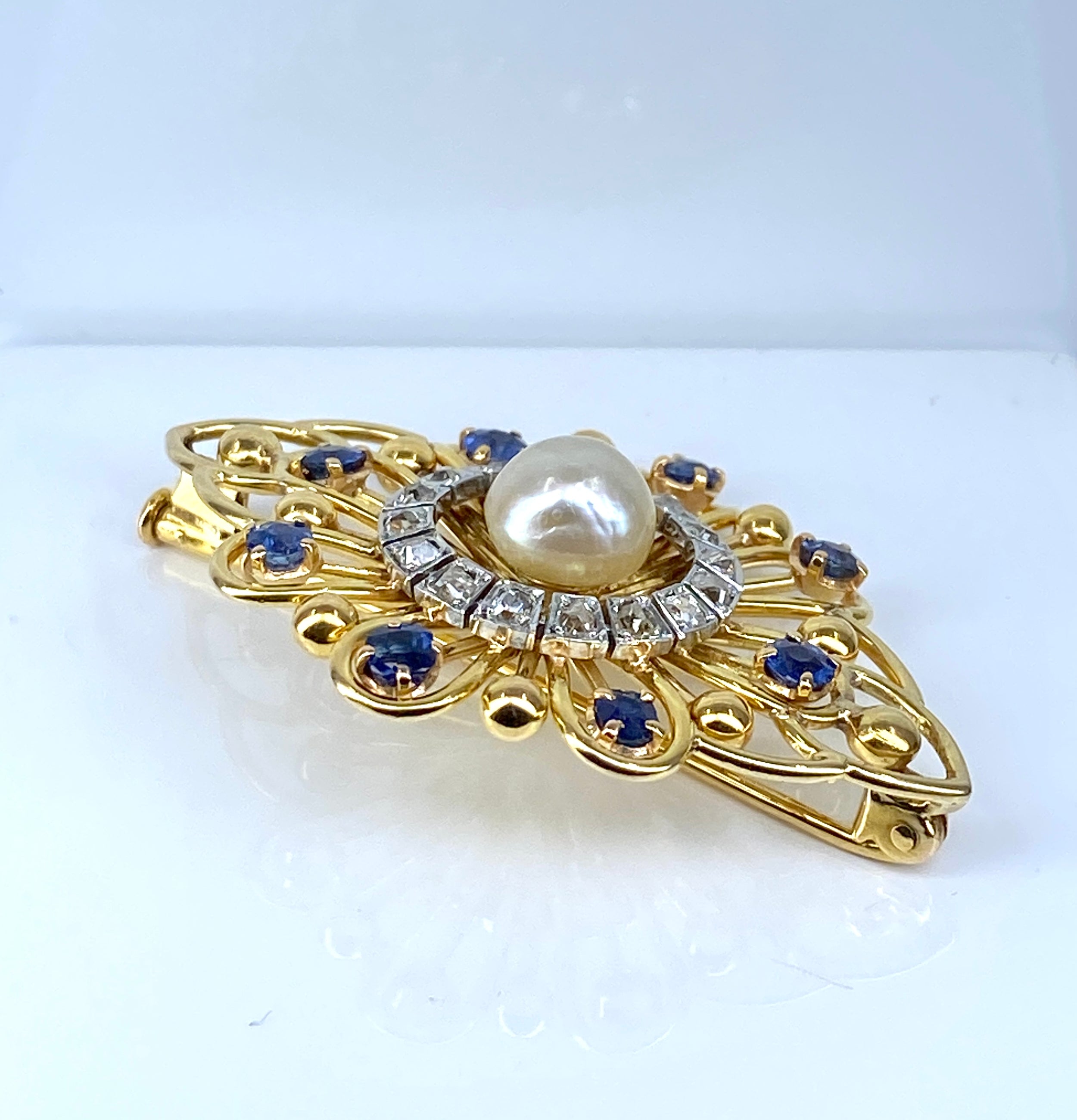 Gold brooch with sapphires, a pearl, and diamonds