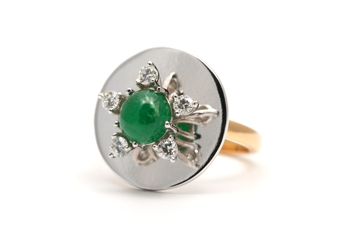 Ring in white gold, yellow gold, emeralds, and diamonds