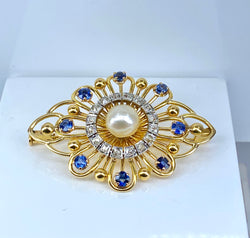 Gold brooch with sapphires, a pearl, and diamonds