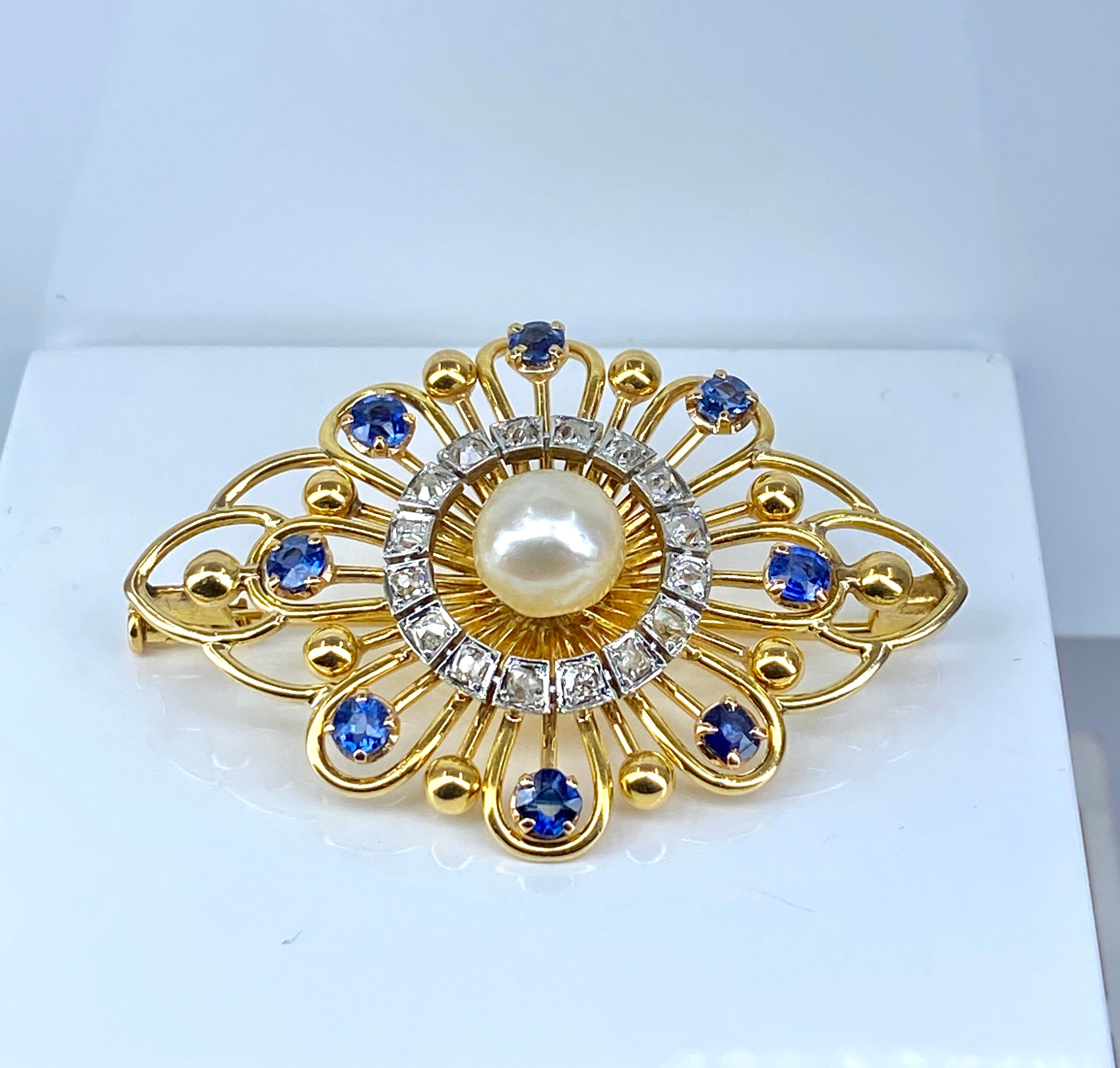 Gold brooch with sapphires, a pearl, and diamonds