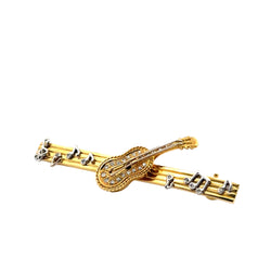 Brooch in yellow gold, white gold, and diamonds