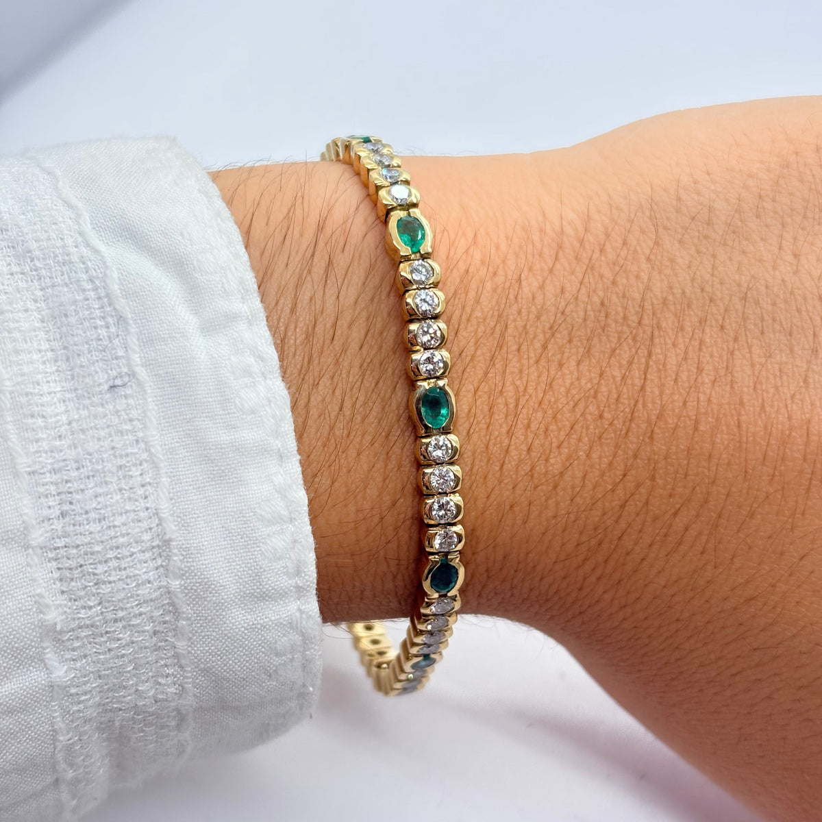 "Ligne" Bracelet in Yellow Gold, Emeralds, and Diamonds