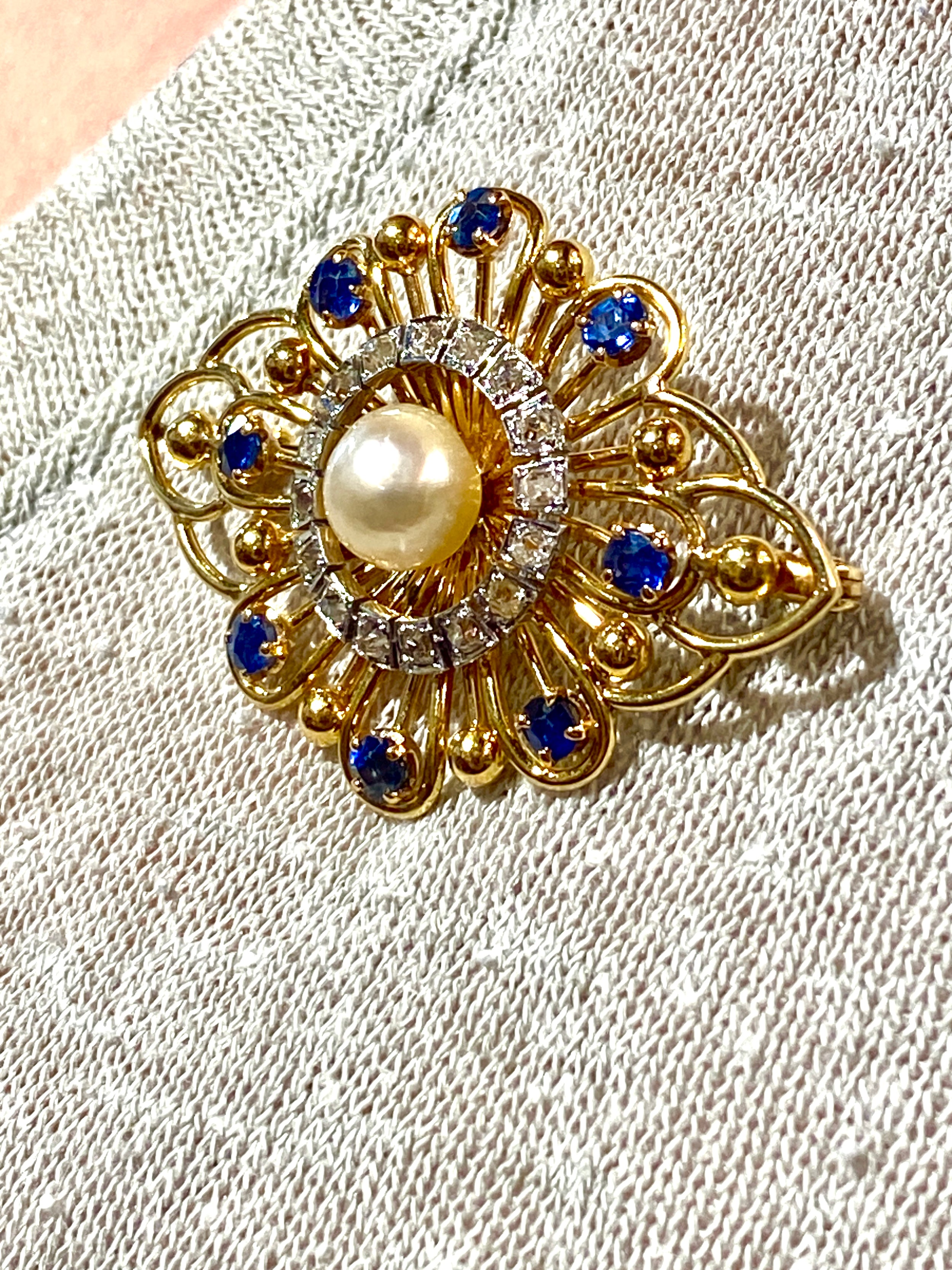 Gold brooch with sapphires, a pearl, and diamonds