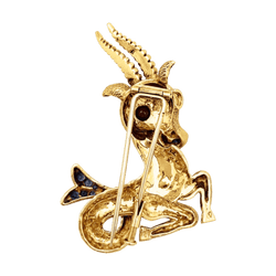 Broche-clip, "Capricorne", or jaune, rubis, saphirs.