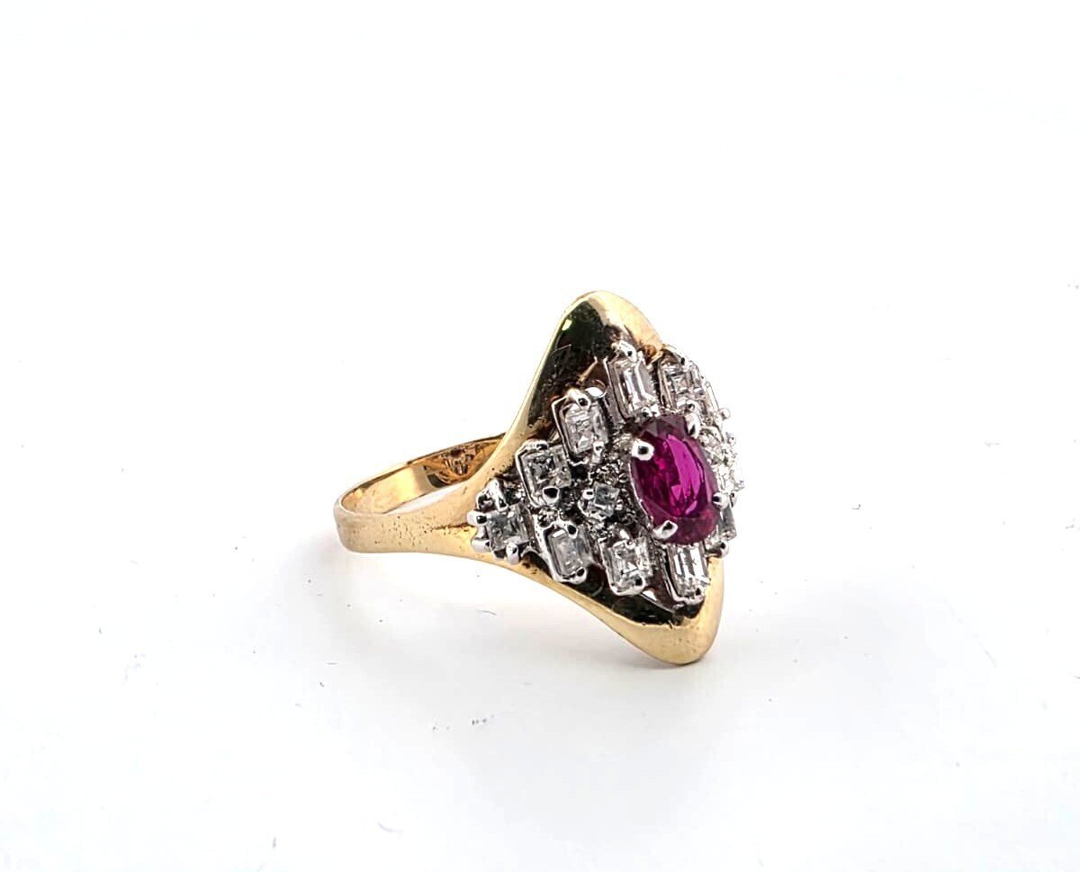 18-karat yellow gold ring with a central ruby and diamonds surrounding it