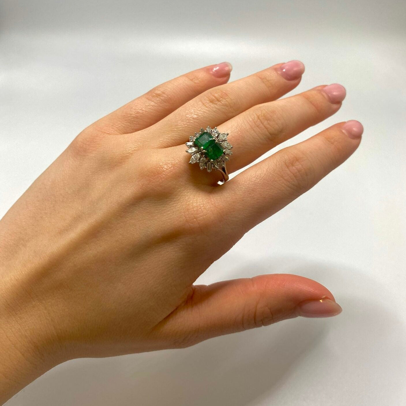 "Entourage" Ring in White Gold, Emeralds, and Diamonds