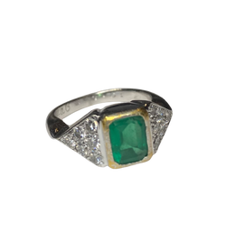 Ring in white gold, yellow gold, emerald, and diamonds