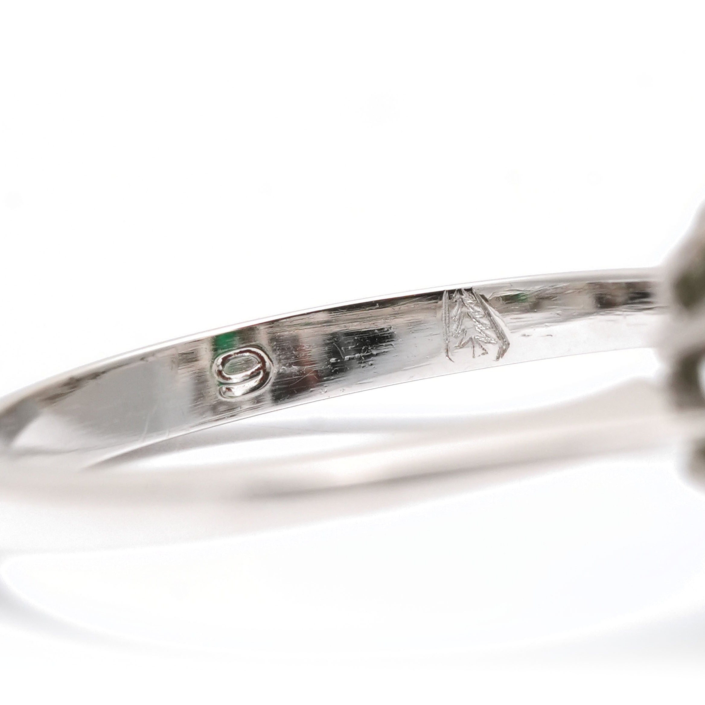 "Entourage" Ring in White Gold, Emerald, and Diamonds