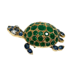 GUBELIN brooch in yellow gold, with emeralds, sapphires, and diamonds