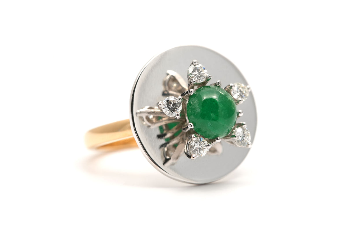 Ring in white gold, yellow gold, emeralds, and diamonds