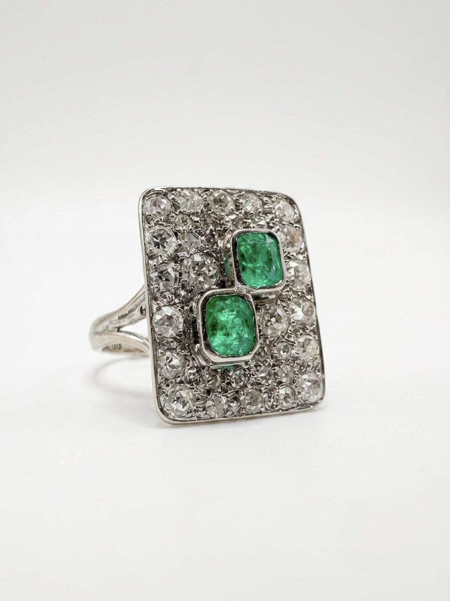 White gold ring with emeralds and diamonds