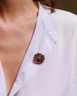 Brooch made of yellow gold, silver, Enamel, and diamonds.