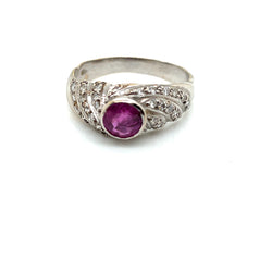 Gold bangle ring with a pink sapphire and diamonds
