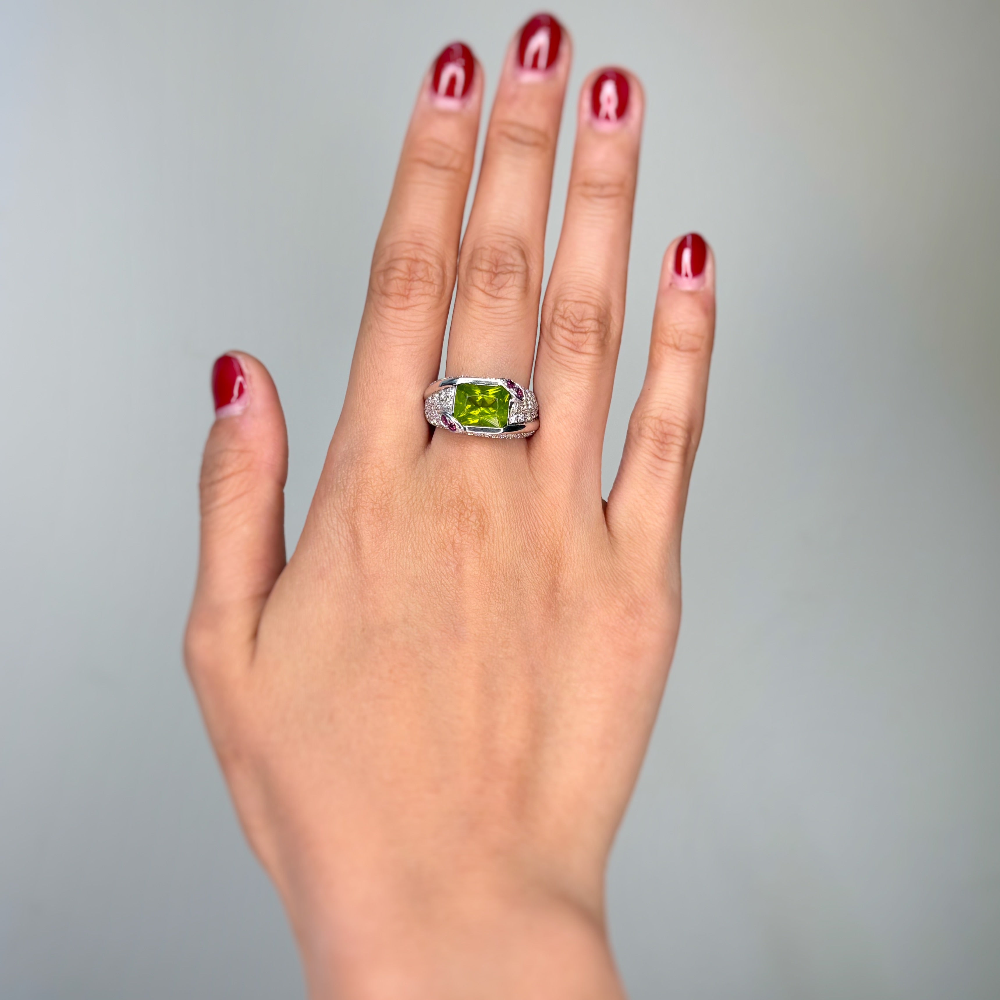 White gold ring with Peridot, garnets, and diamonds