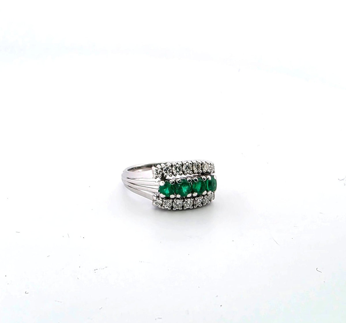 White gold ring with emeralds and diamonds