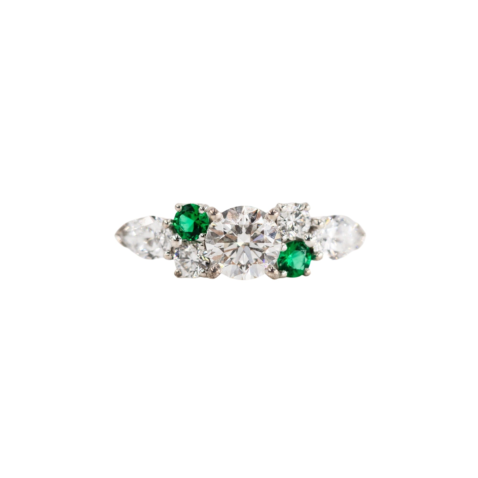 Entourage Ring in white gold, emeralds, and diamonds