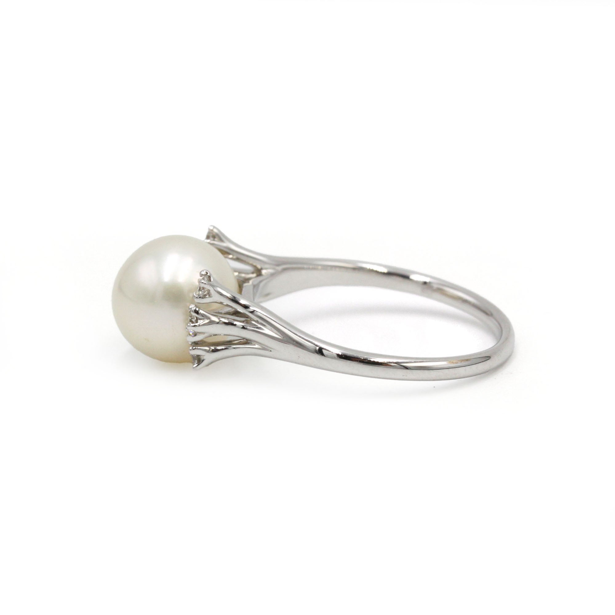 White gold ring with diamonds and a pearl