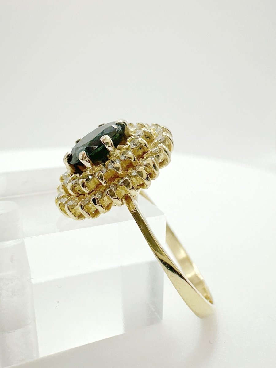 ANILLO DE ZAFIRO AZUL OSCURO CON HALO DE DIAMANTES EN ORO AMARILLO - Castafiore