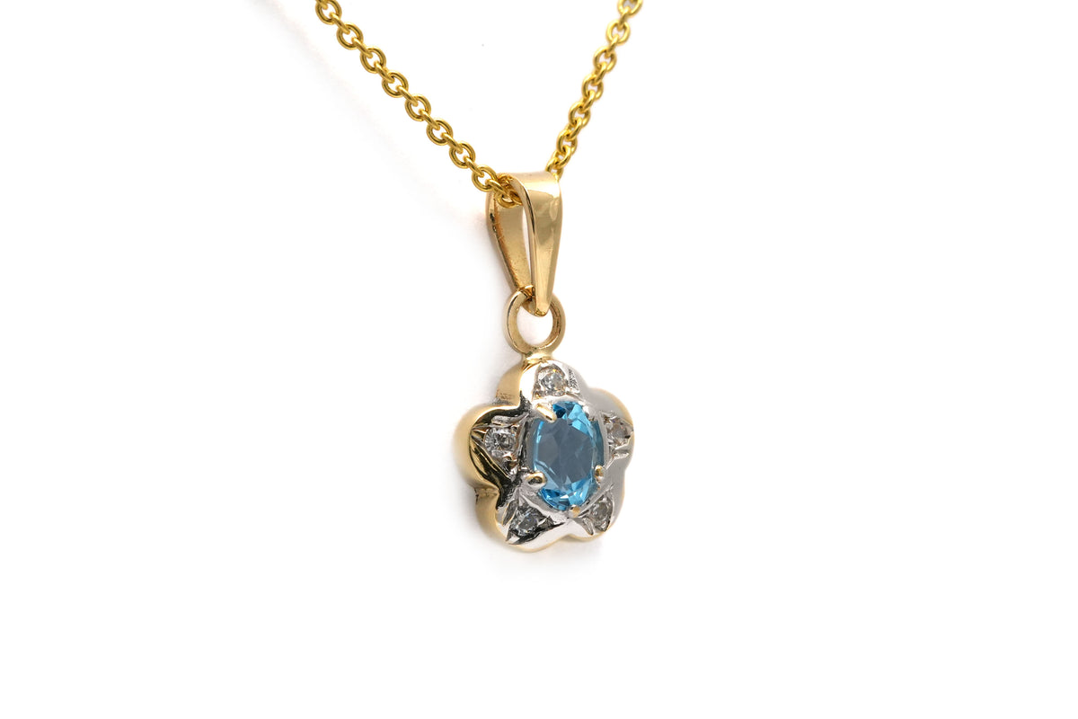 Pendant made of white gold, yellow gold, topaz, and diamonds