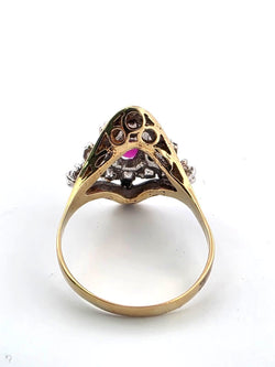 18-karat yellow gold ring with a central ruby and diamonds surrounding it
