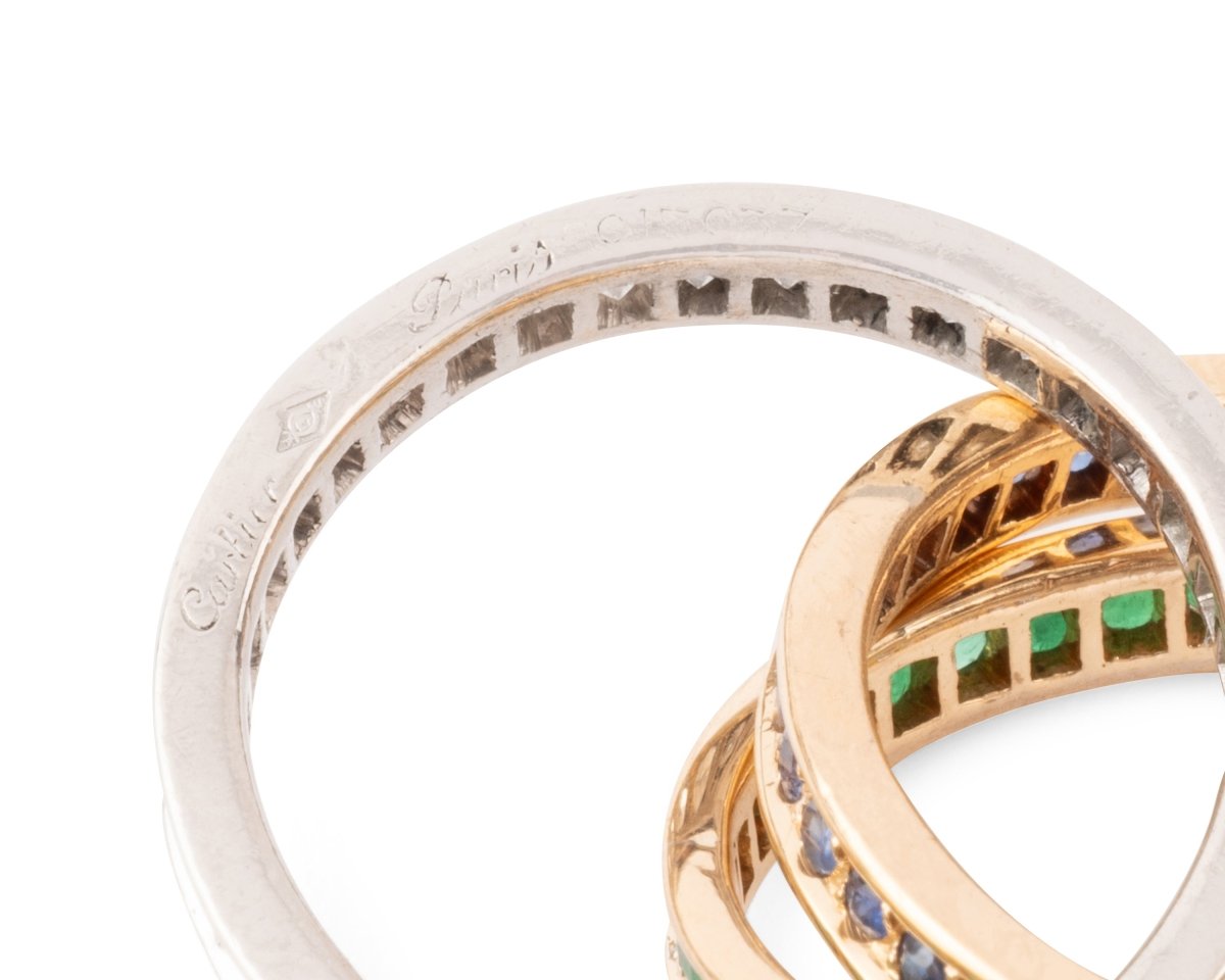 Bague CARTIER "Trinity" en or jaune, émeraudes, saphirs et diamants - Castafiore