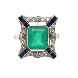 Bague Entourage en platine, émeraude, saphirs et diamants - Castafiore