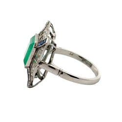 Bague Entourage en platine, émeraude, saphirs et diamants - Castafiore