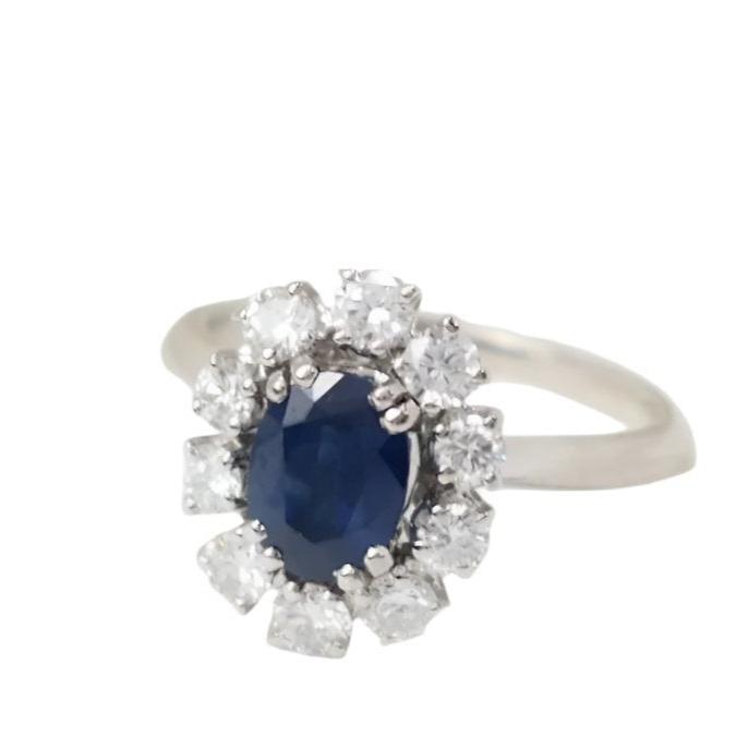 Bague marguerite en or blanc, saphir ovale et diamants - Castafiore