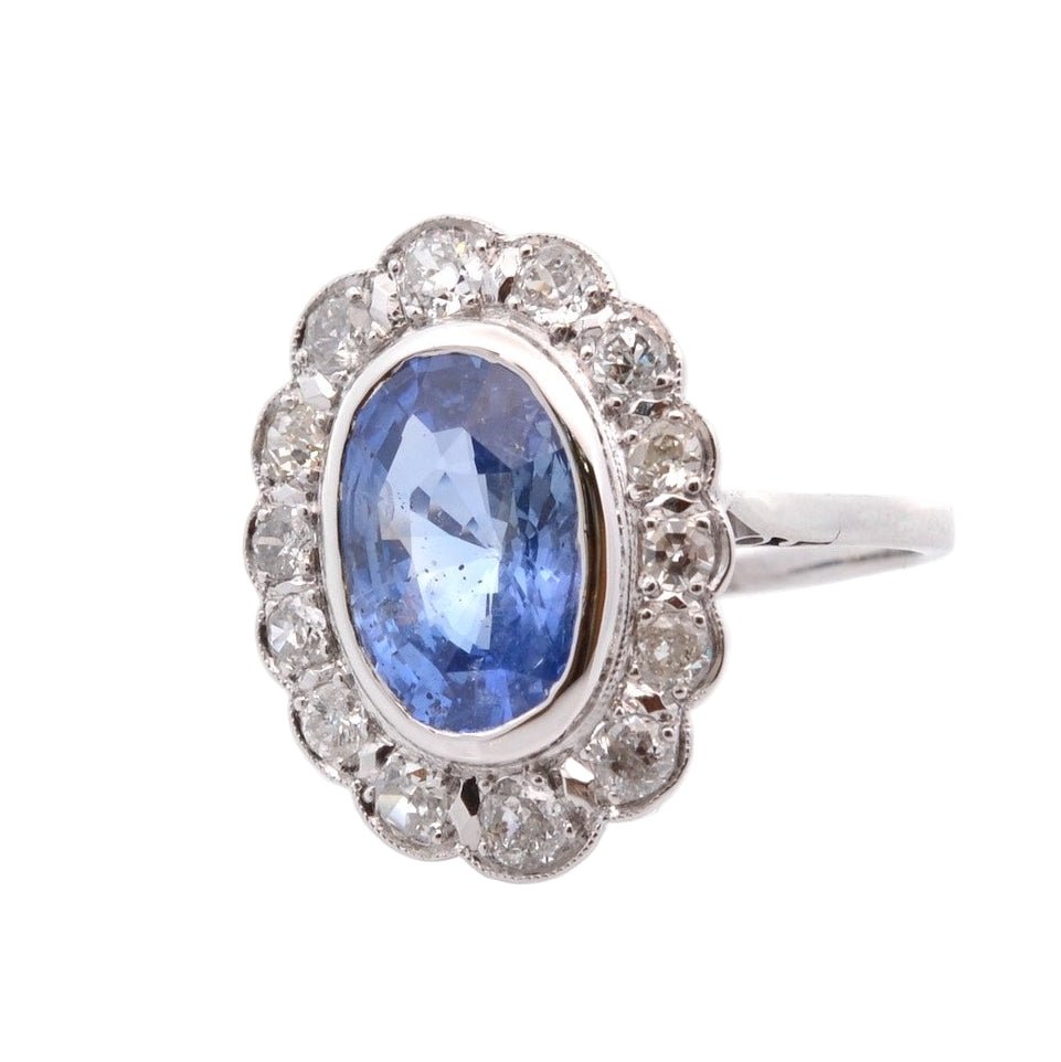 Bague Marguerite en platine, or jaune, saphir, et diamants - Castafiore