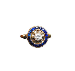 Bague Ornée d'Un Diamant, Entourage De Saphirs Calibrés - Castafiore
