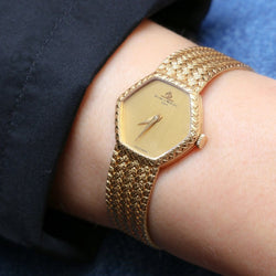 BAUME & MERCIER Montre vintage or jaune maille tressée - Castafiore