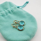 Boucles d'oreilles Pendantes TIFFANY & CO "Olive Leaf", en or jaune et topazes bleues - Castafiore