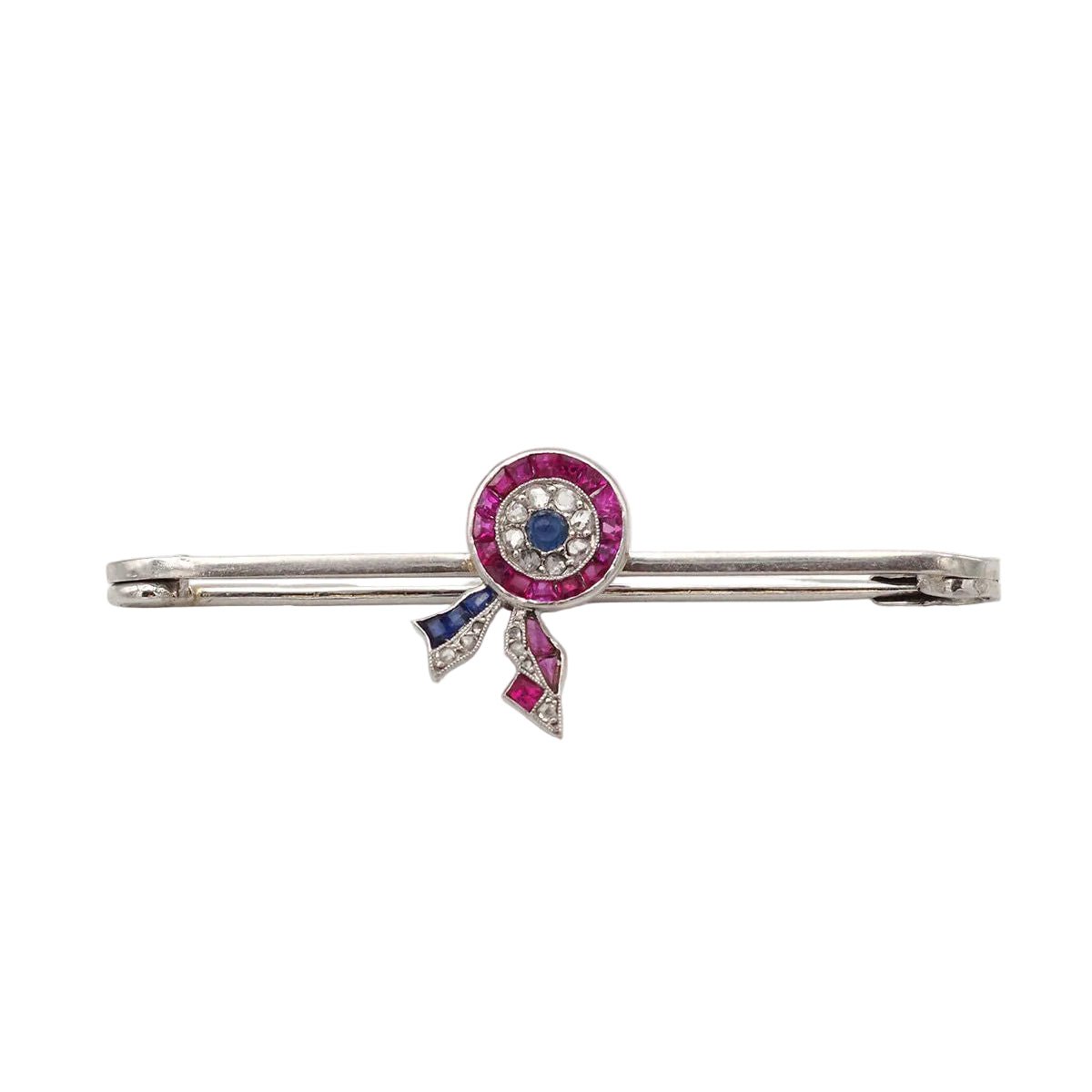 Broche Épingle CARTIER en platine, rubis et saphirs - Castafiore