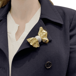 Brooch Fred, "Nœud", yellow gold and steel.