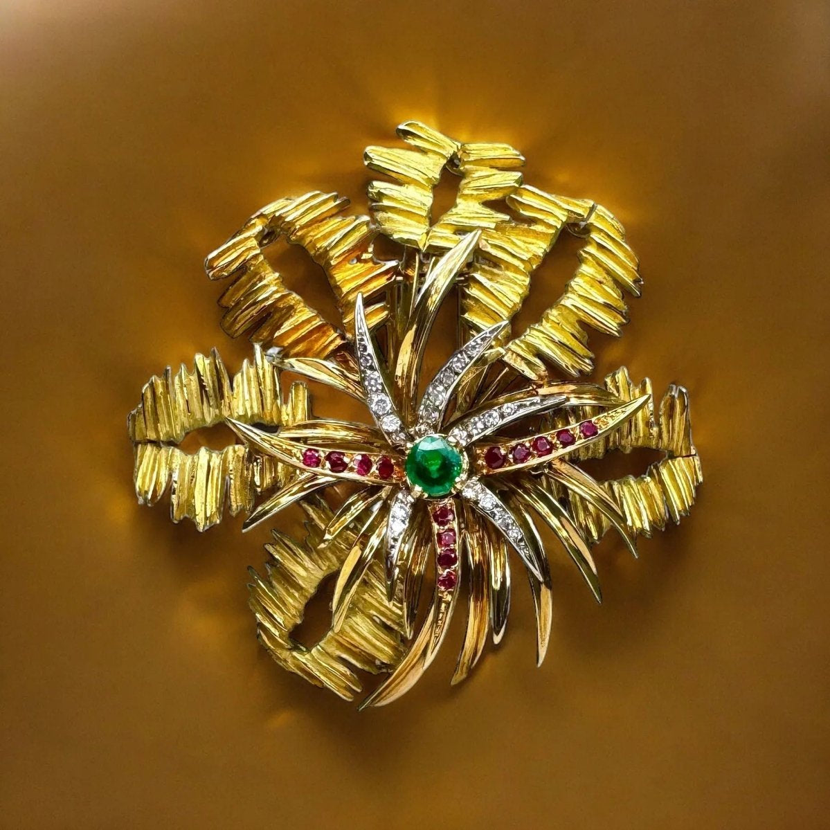 Broche MELLERIO en or jaune, émeraude, rubis et diamants - Castafiore