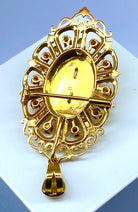 Broche pendentif en or jaune 18 carats en grenats, émeraude et diamants - Castafiore