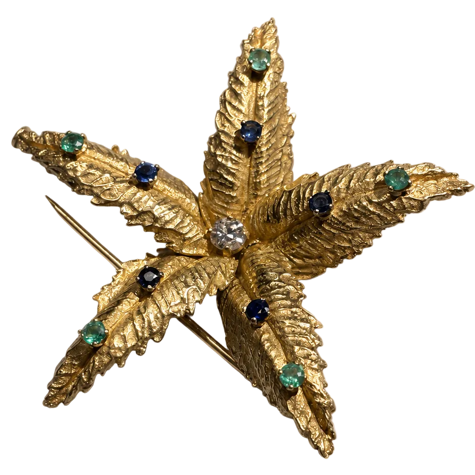 BOUCHERON brooch in yellow gold, emeralds, sapphires, and diamonds