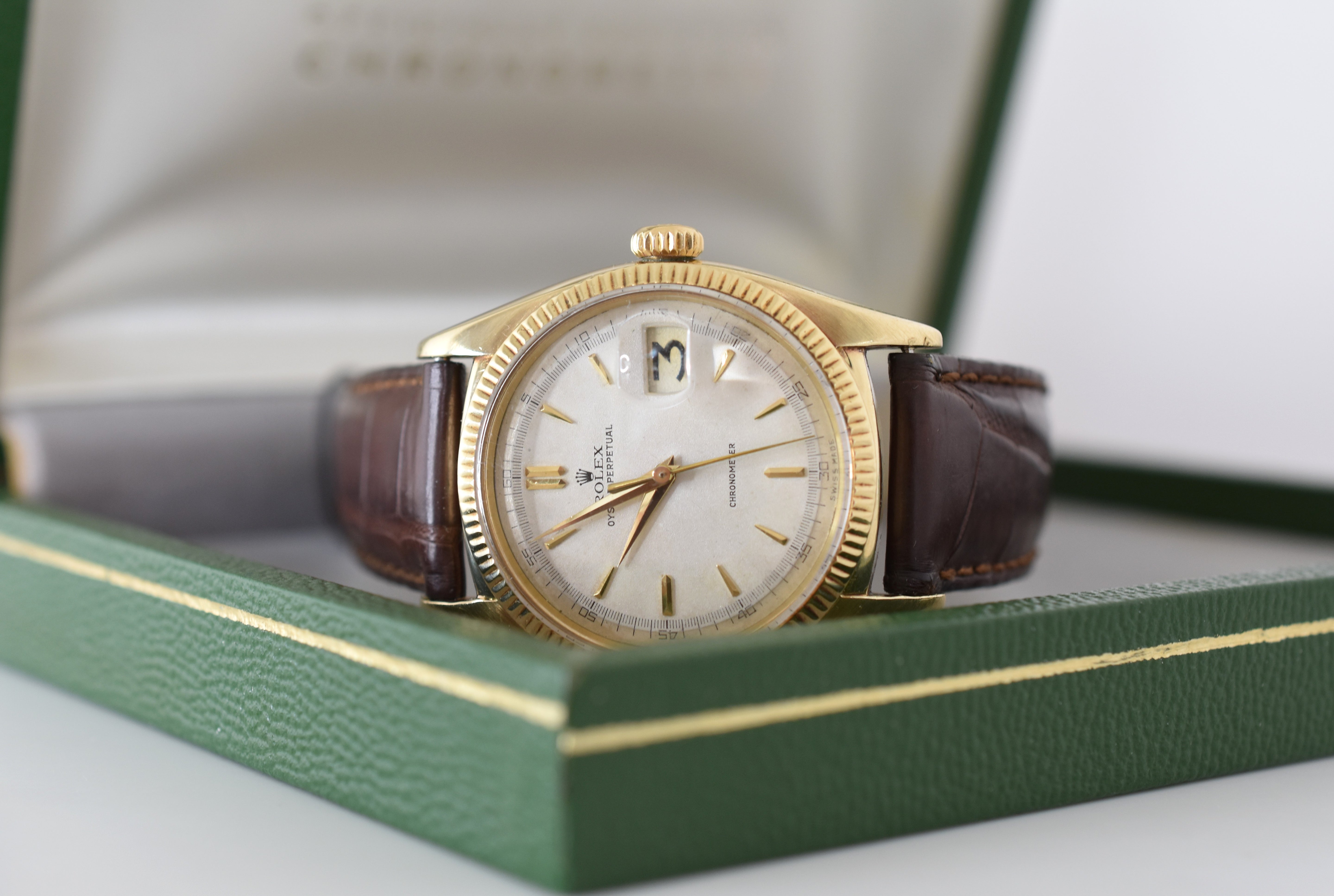 ROLEX "Oyster Perpetual Date Ovettone" watch in yellow gold and leather