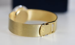 CHOPARD watch, Ref. 810, 18-carat yellow gold and diamonds, solid gold integrated bracelet, circa 1980.