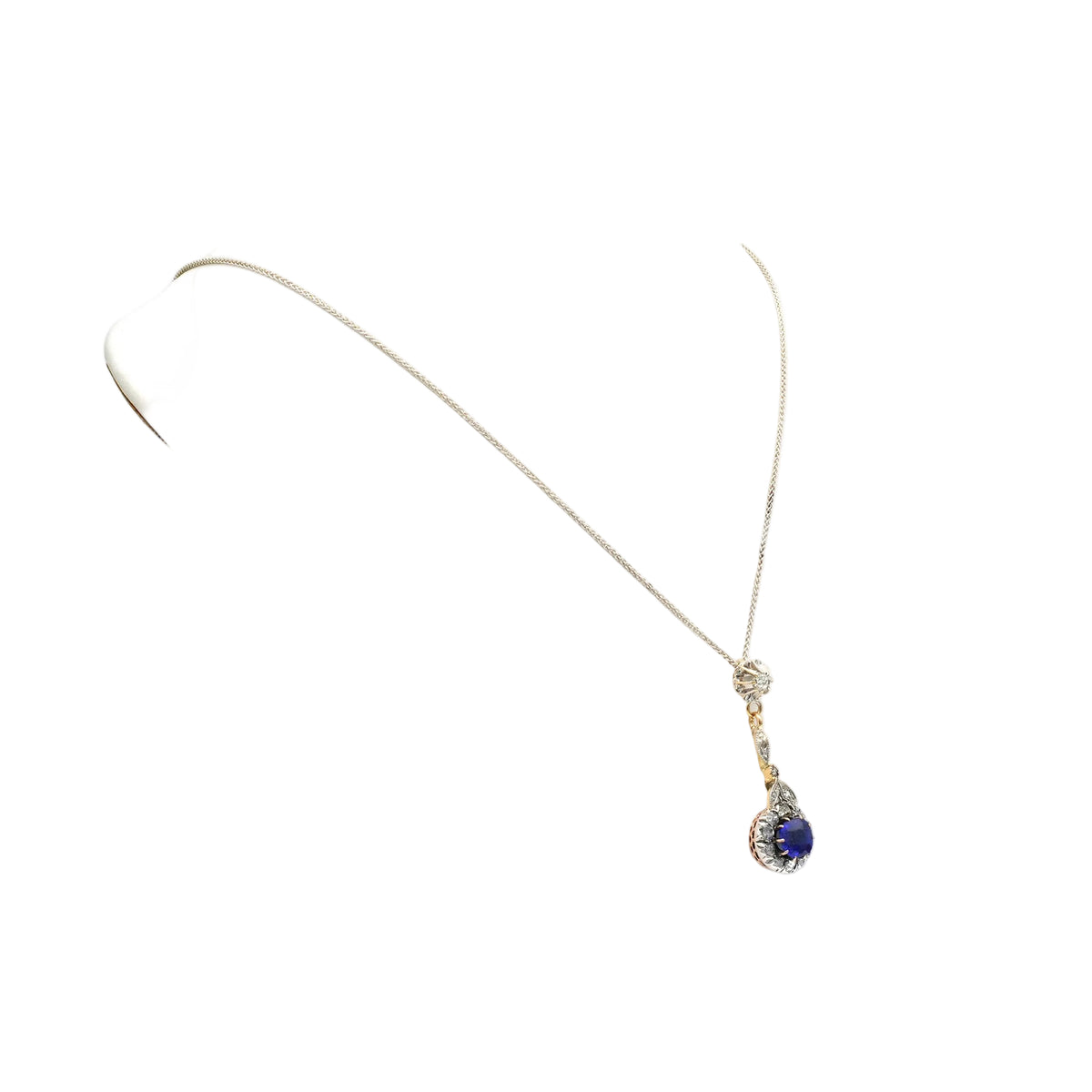Necklace with a pendant made of yellow gold, silver, sapphire, and diamonds