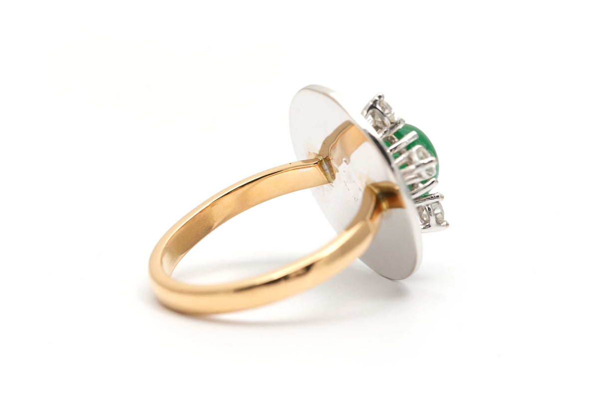 Ring in white gold, yellow gold, emeralds, and diamonds
